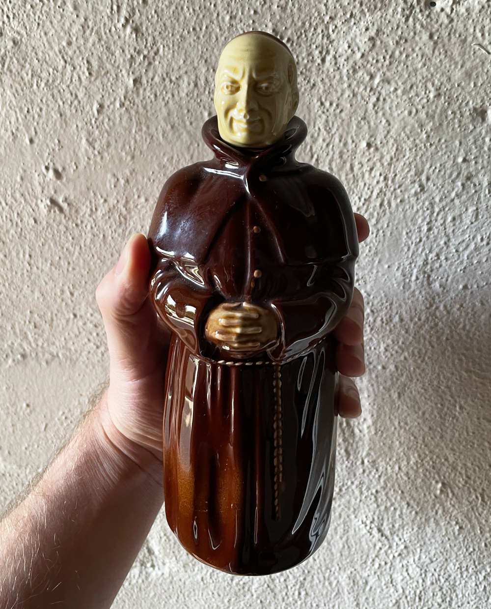 Paul Dalla Rosa holding a statue of friar